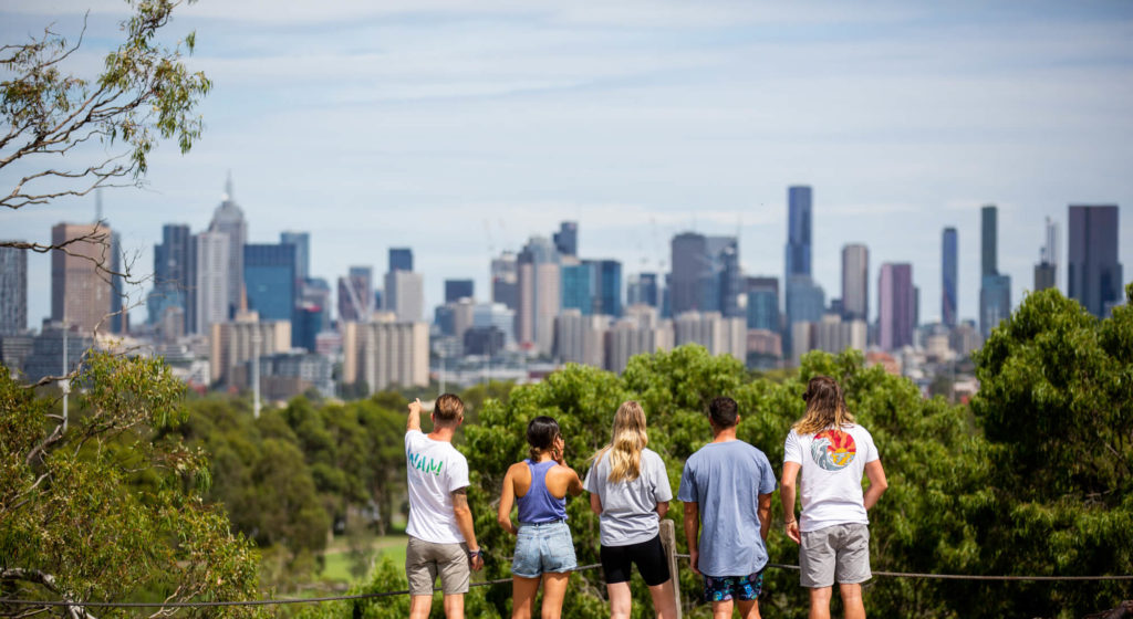 A group of people and a guide admiring melbourne skyline on an eco-tour